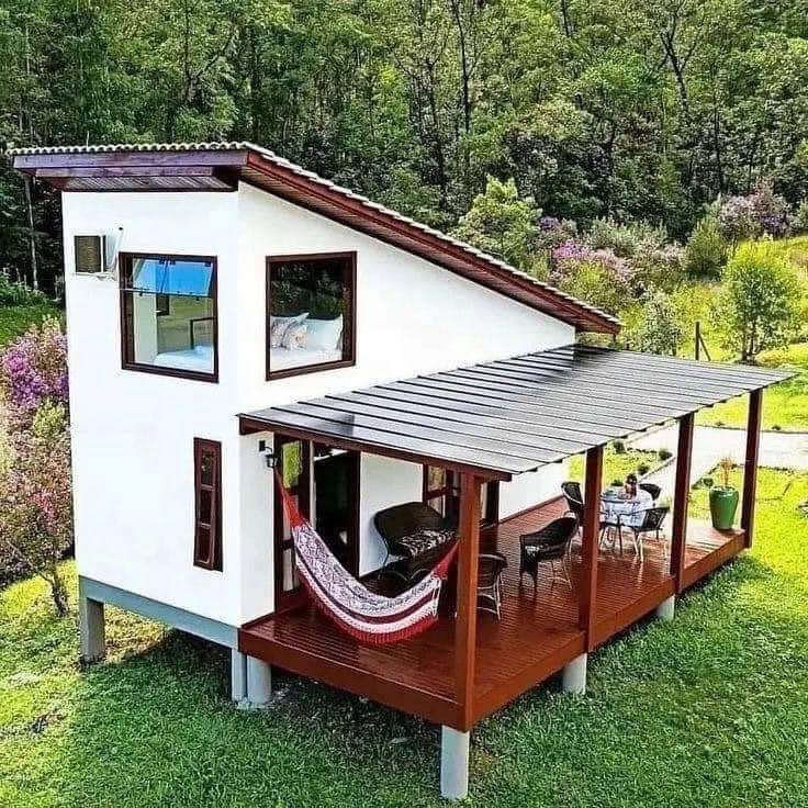 This meme is an image of a small, modern, and minimalist house with a single room and a large deck. The text "Tiny House, Big Ego" appears above the house, suggesting that the house's owner is trying to make up for its small size by being overly proud and self-important. The image is likely meant to be humorous and ironic, poking fun at the idea of someone trying to make a big deal out of a tiny house.